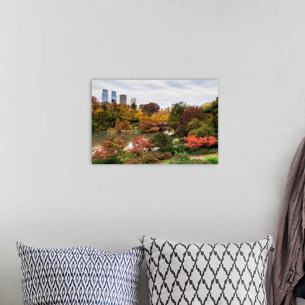 A bohemian room featuring View of the Central Park Pond and the New York skyline. The foliage is at peak color.