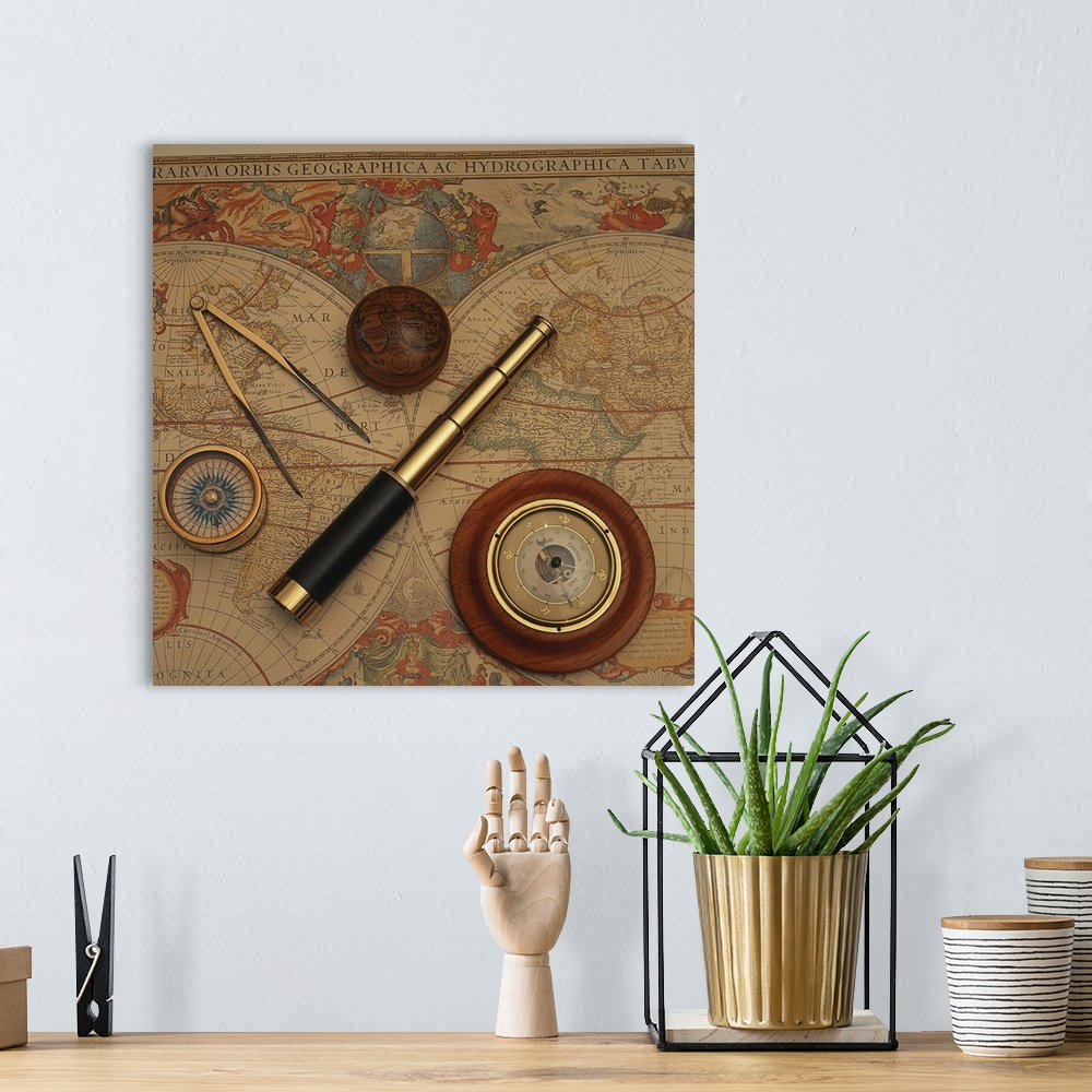 A bohemian room featuring Square, oversized photograph of an antique world map with vintage navigation tools such as a comp...