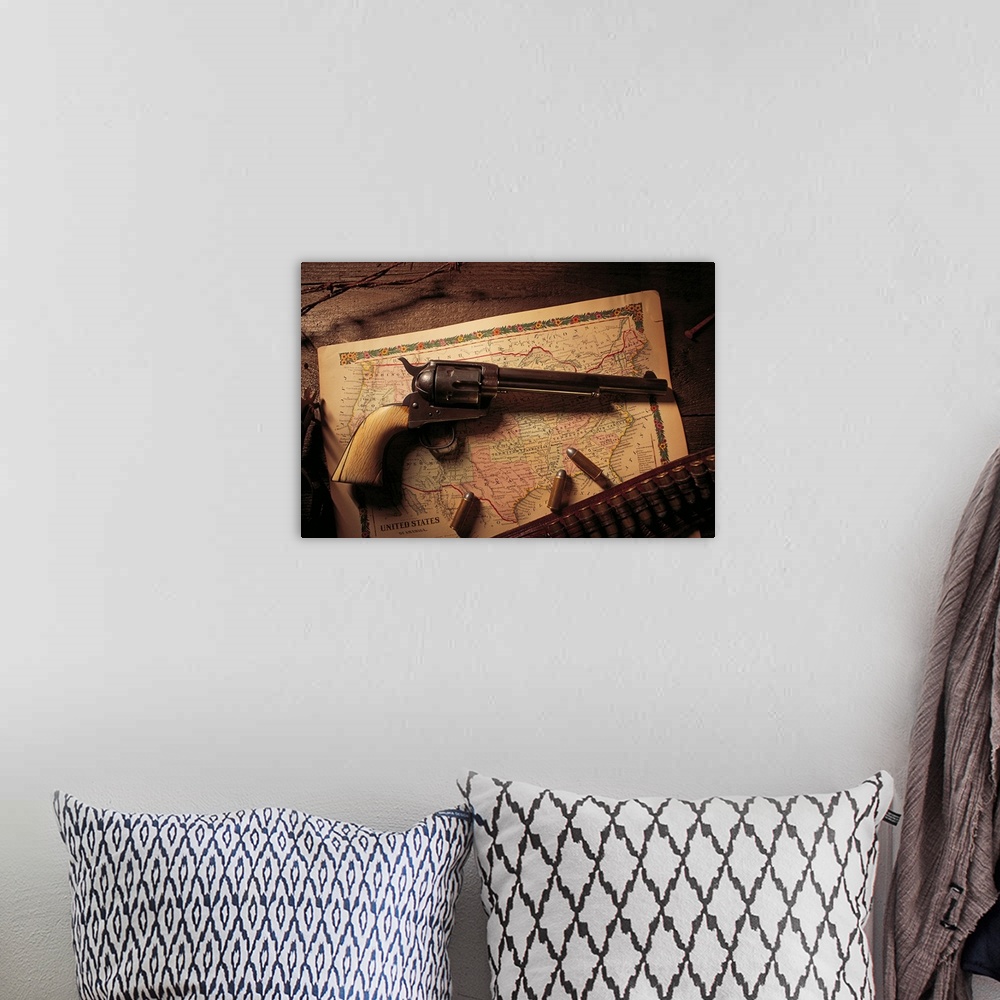 A bohemian room featuring Vintage revolver with bullets and map