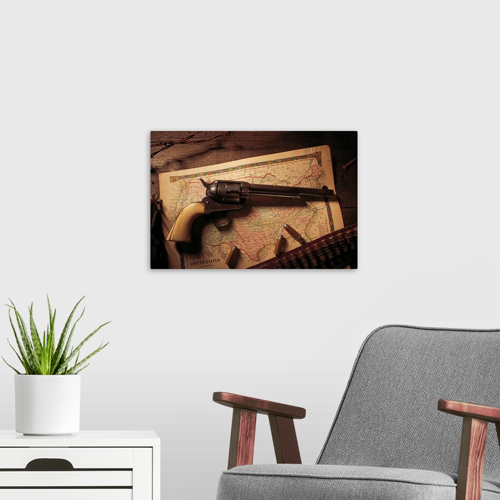 A modern room featuring Vintage revolver with bullets and map
