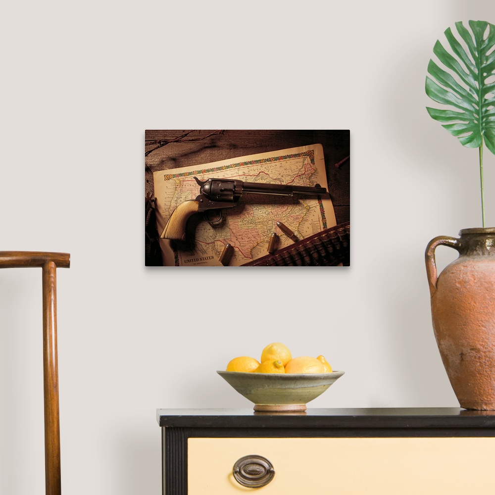 A traditional room featuring Vintage revolver with bullets and map