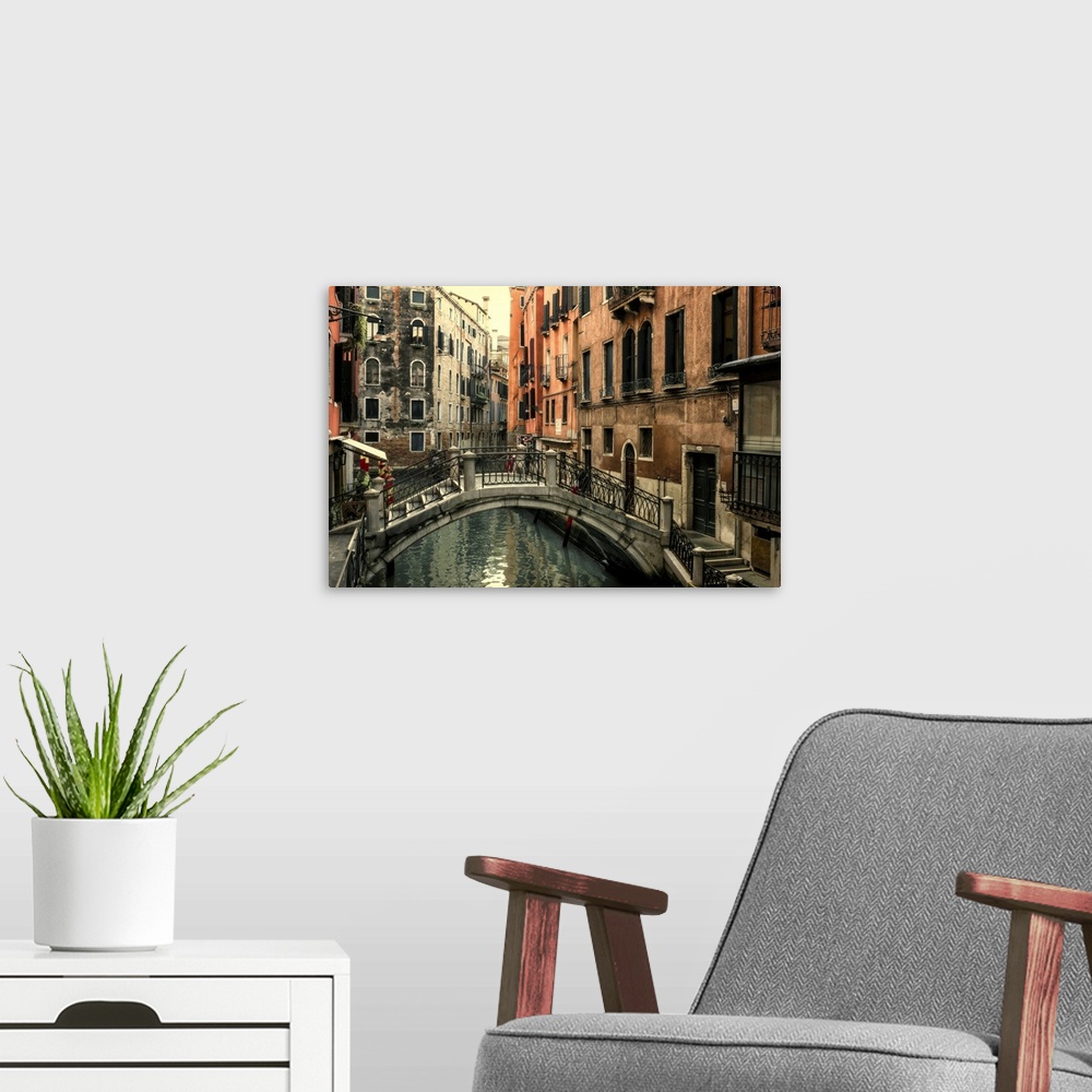 A modern room featuring Short bridge over one of the many canals that crisscross Venice.