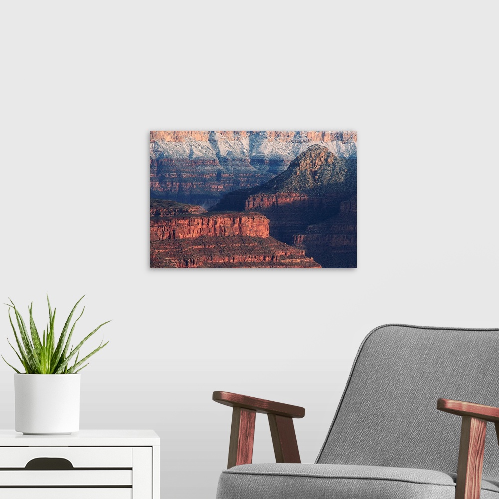 A modern room featuring Colorful bands show layers of sediment on the walls of the Grand Canyon in Arizona.