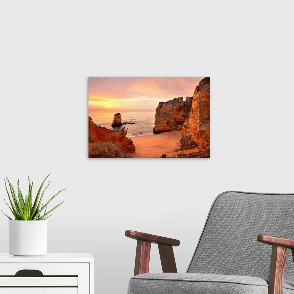 A modern room featuring Warm sunrise seascape at Praia Dona Ana Beach in Lagos, Portugal.