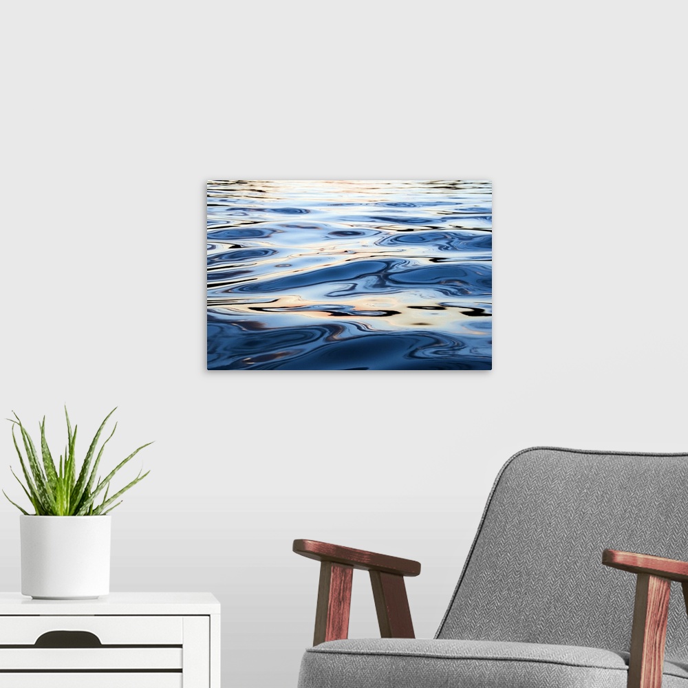 A modern room featuring This is a close up nature photograph of the rippling surface of a body of water reflecting sunlig...