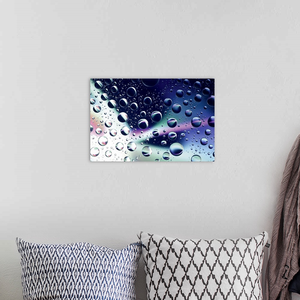 A bohemian room featuring Horizontal close up photograph on a giant wall hanging of many water droplets sitting on a clear ...
