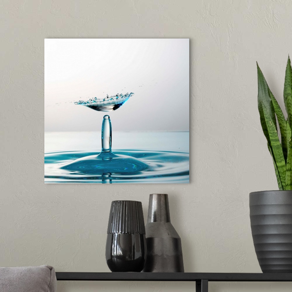 A modern room featuring Water drops colliding to shape an umbrella splash, close-up, studio shot