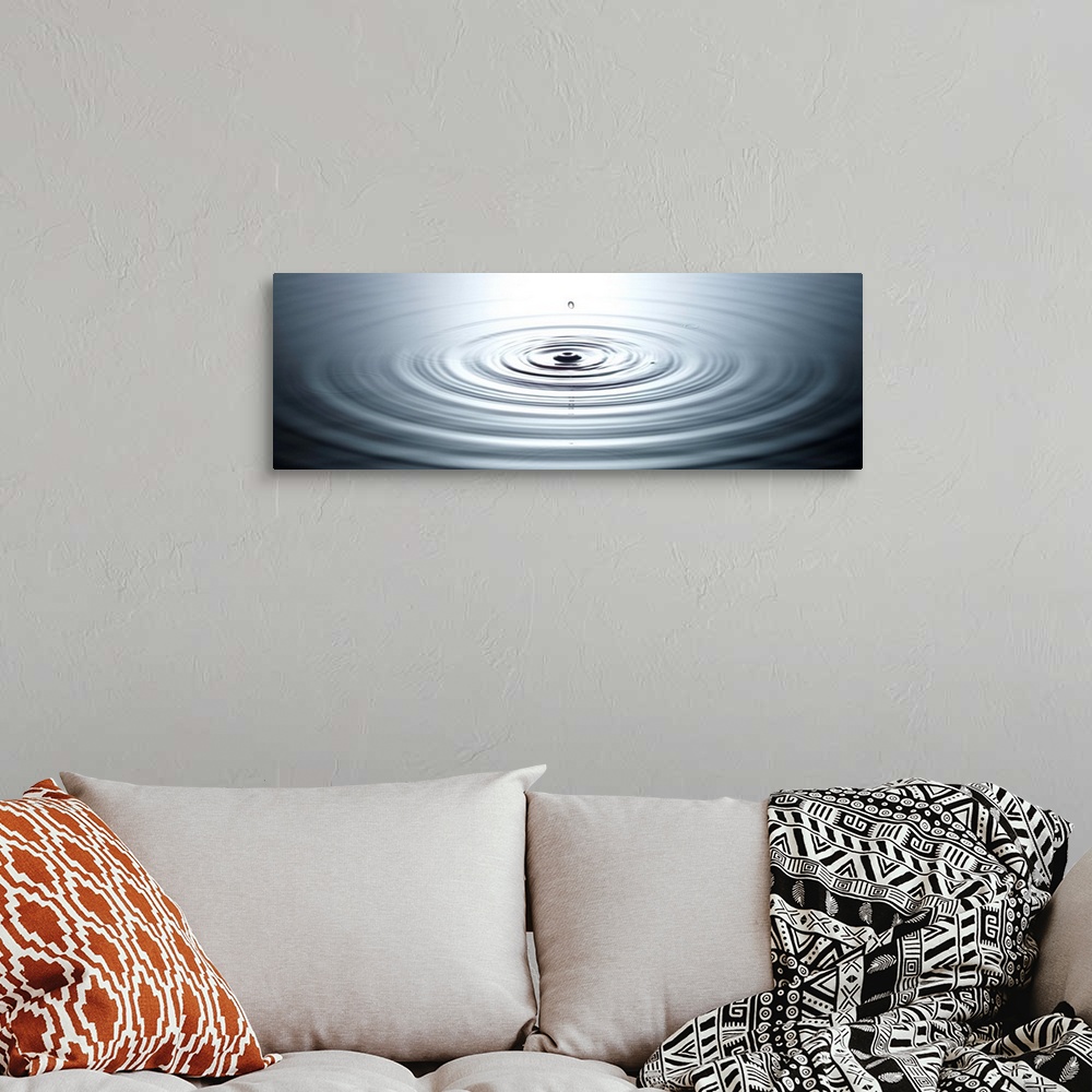 A bohemian room featuring drop of water causing ripples in still pool of water