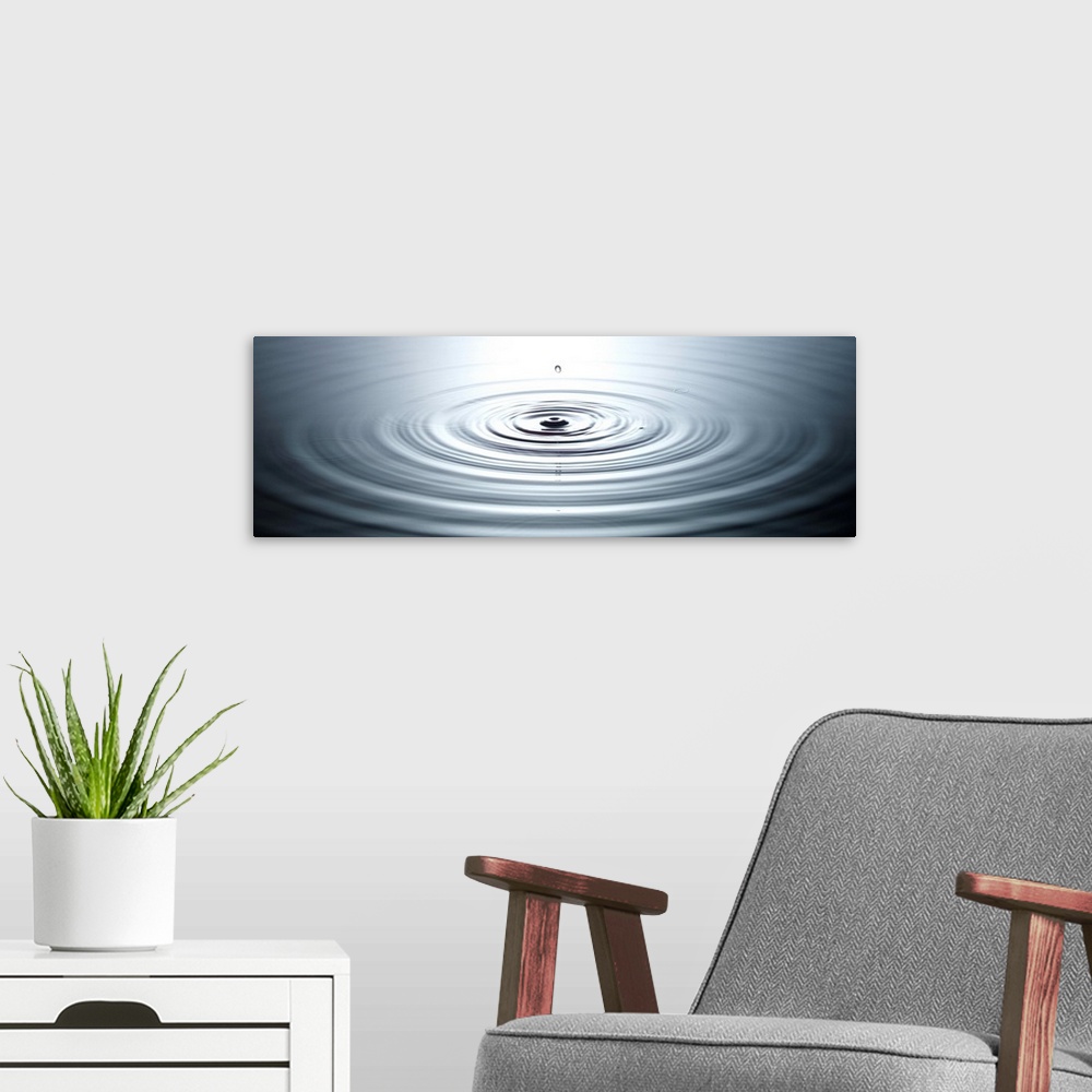 A modern room featuring drop of water causing ripples in still pool of water