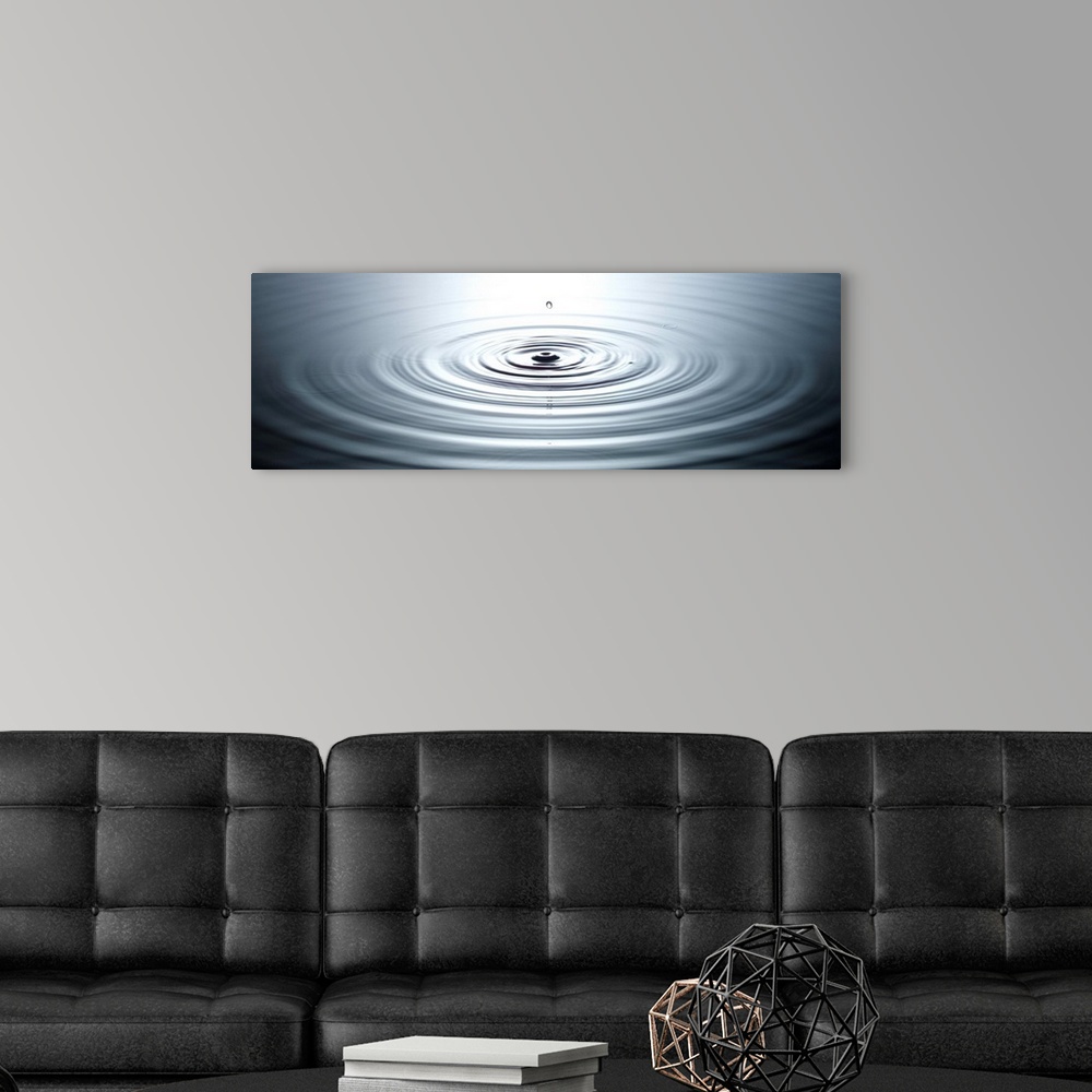 A modern room featuring drop of water causing ripples in still pool of water