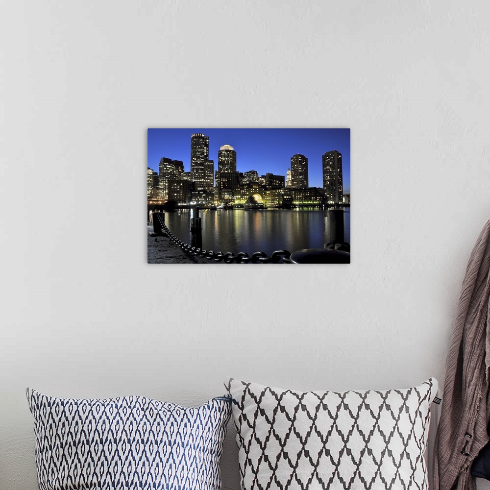 A bohemian room featuring Downtown Boston and Financial District skyline lit up against a deep blue, late twilight sky, wit...