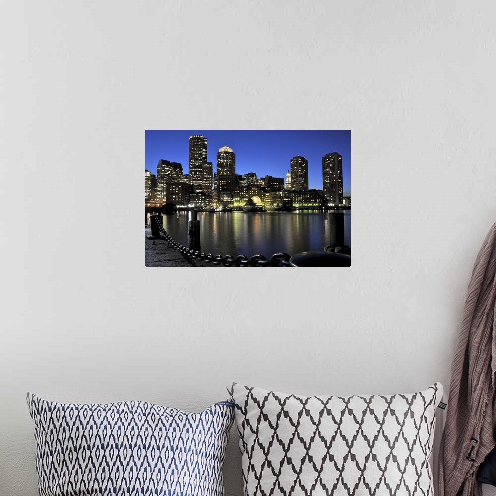 A bohemian room featuring Downtown Boston and Financial District skyline lit up against a deep blue, late twilight sky, wit...