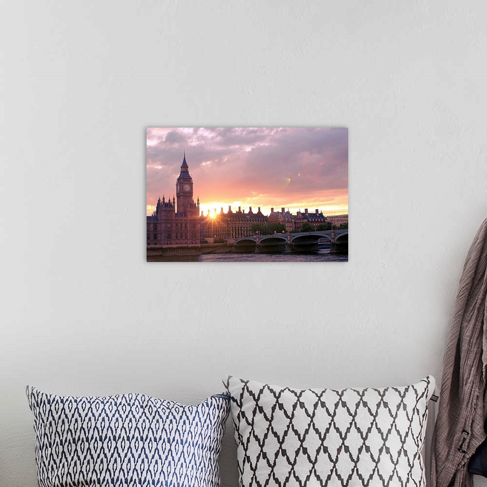 A bohemian room featuring Big photograph shows the sun beginning to set over some of the gothic revival architecture that s...