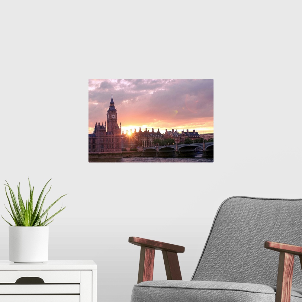 A modern room featuring Big photograph shows the sun beginning to set over some of the gothic revival architecture that s...