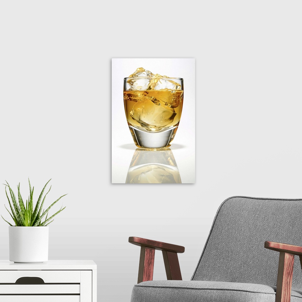A modern room featuring Bourbon whiskey with three ice cubes in a low ball glass.