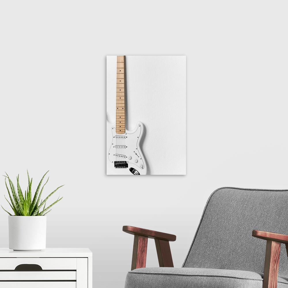 A modern room featuring White electric guitar