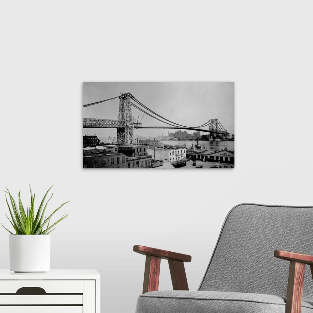 A modern room featuring The Williamsburg bridge extends from Delancy Street in the East Village across the East River to ...