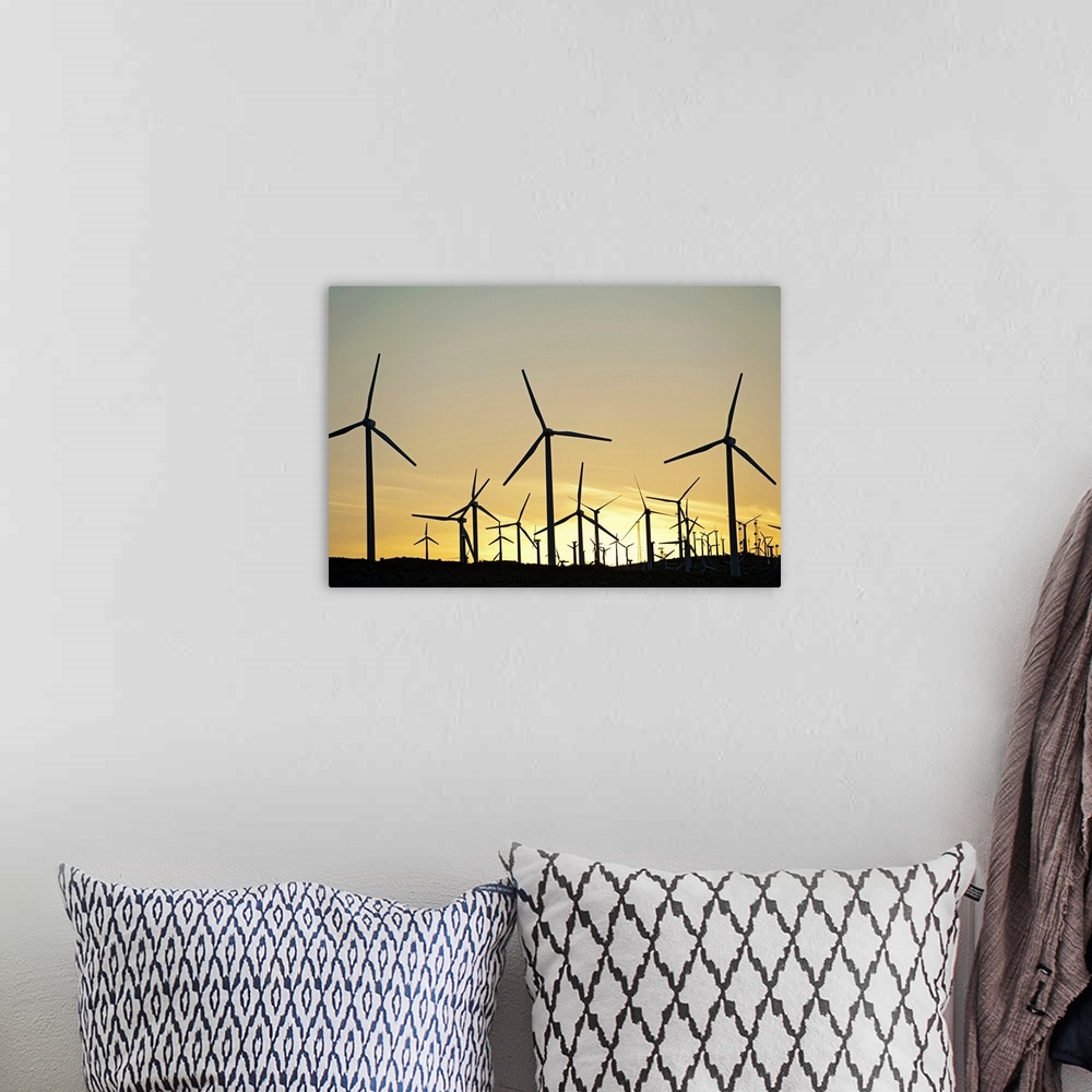 A bohemian room featuring Wind farm in desert at sunset