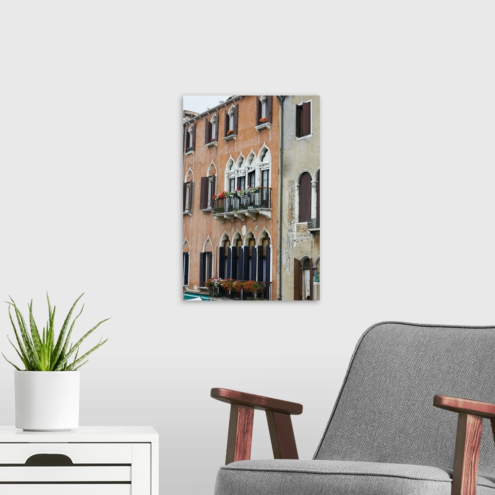 A modern room featuring Window boxes hanging on the railings of windows, Venice, Italy