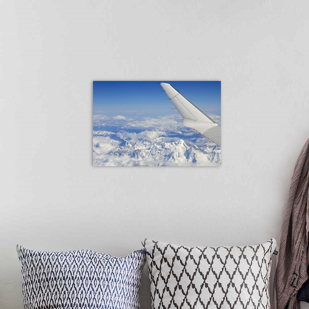 A bohemian room featuring Wings of flying airplane over French Alps, France, (aerial view)
