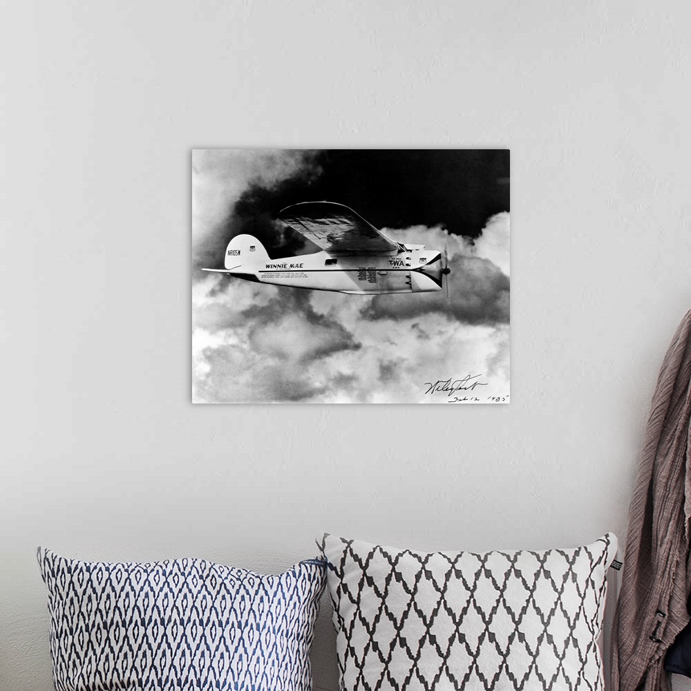 A bohemian room featuring The Winnie Mae of Oklahoma flies through cloudy skies.