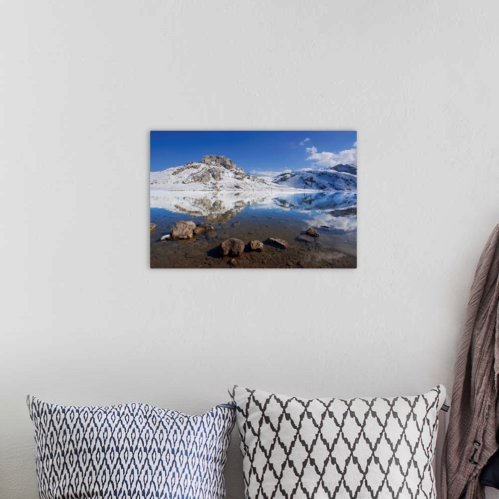 A bohemian room featuring Winter view of lakes of Covadonga, reflection of mountain on lake.