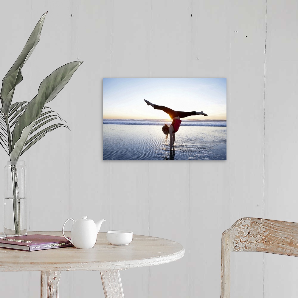 A farmhouse room featuring Woman doing a hand-stand on the beach at sunset.