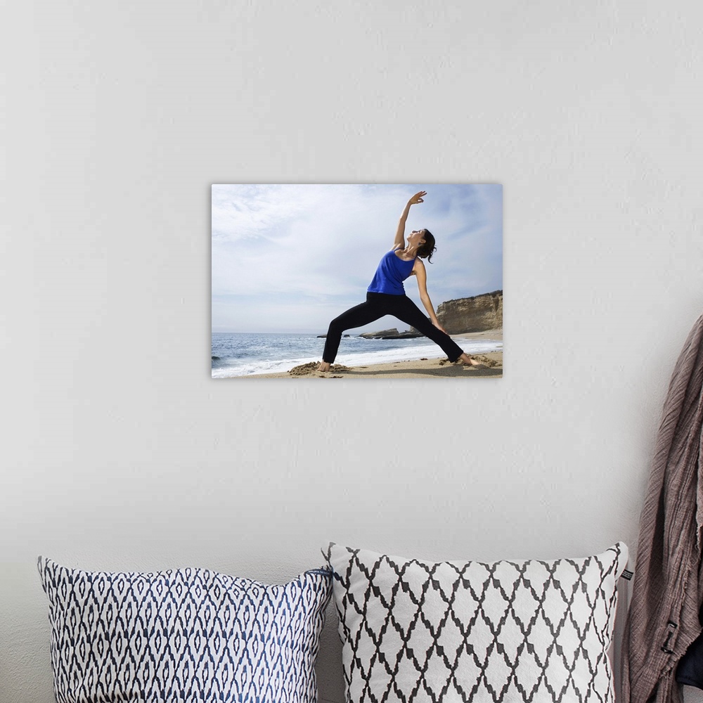 A bohemian room featuring Woman doing yoga on beach