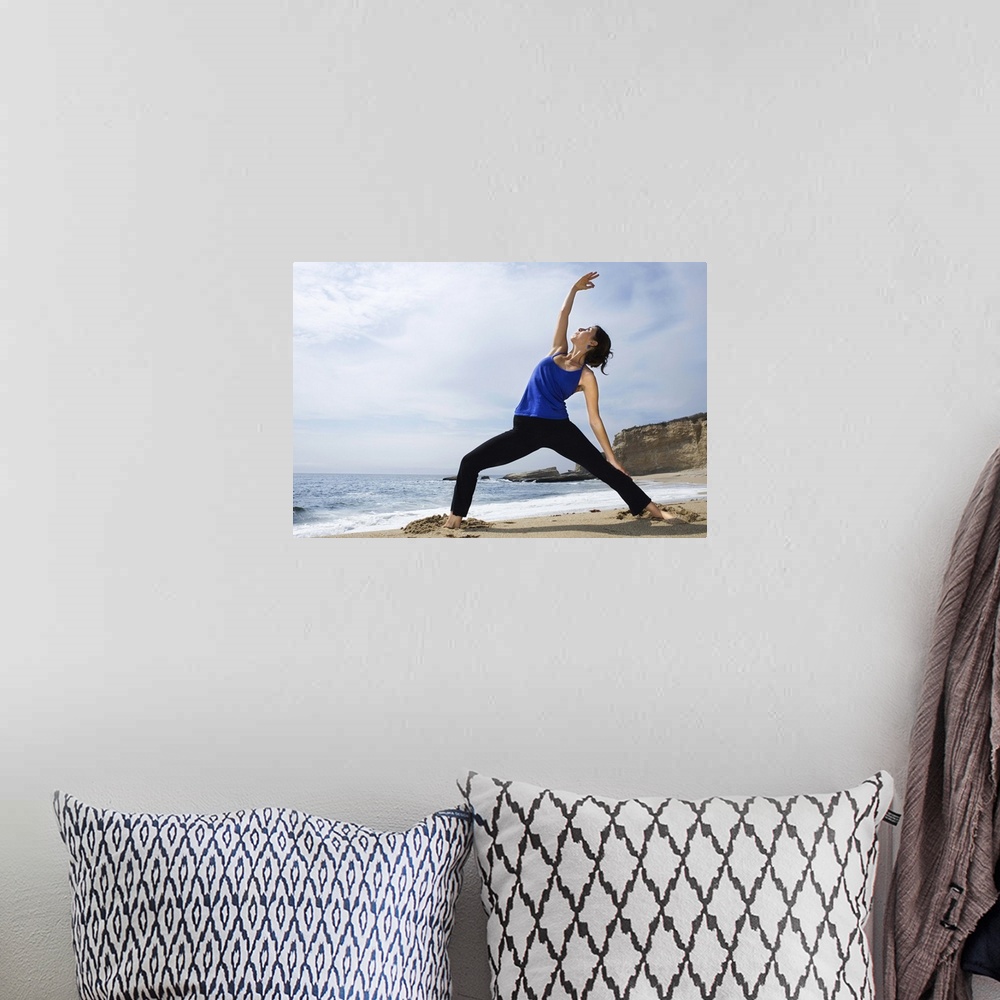 A bohemian room featuring Woman doing yoga on beach