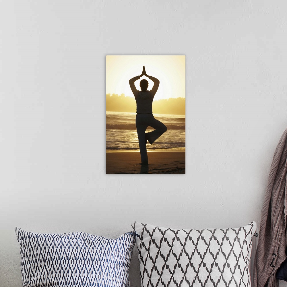 A bohemian room featuring Woman doing yoga on beach at sunrise