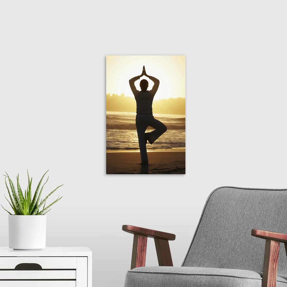 A modern room featuring Woman doing yoga on beach at sunrise