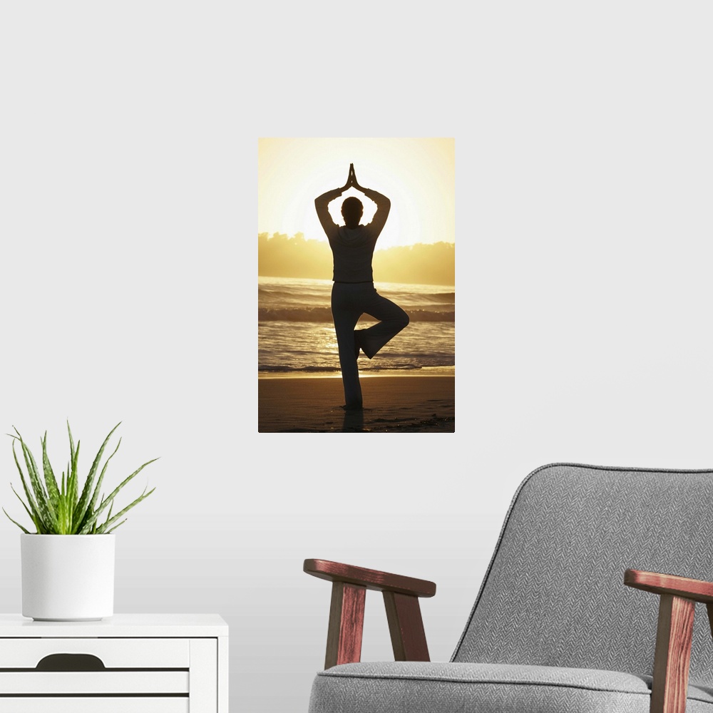 A modern room featuring Woman doing yoga on beach at sunrise