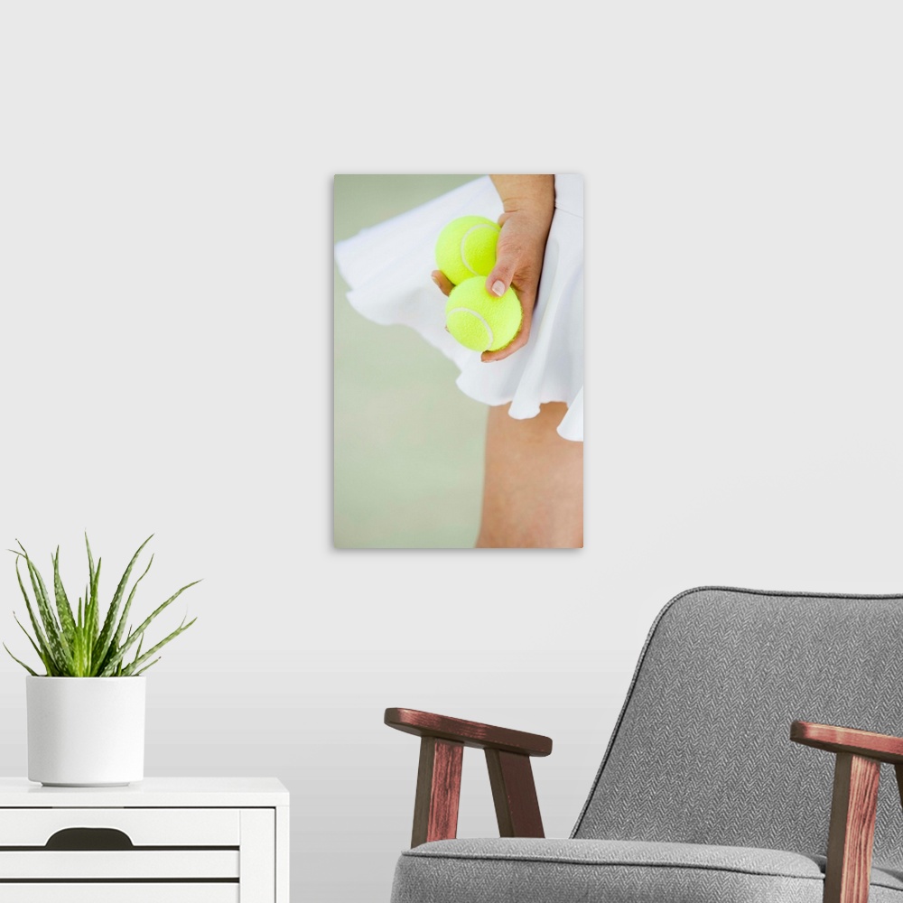 A modern room featuring Woman Holding Tennis Balls