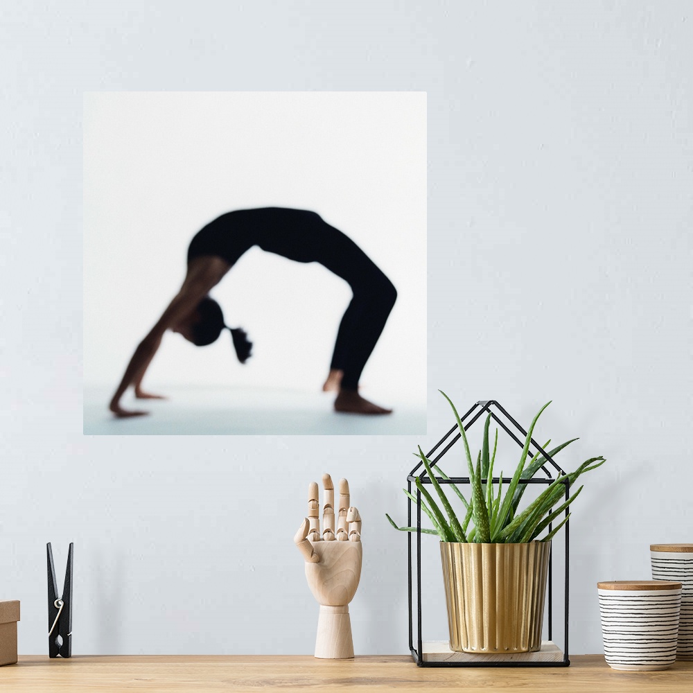 A bohemian room featuring Woman in yoga backbend pose