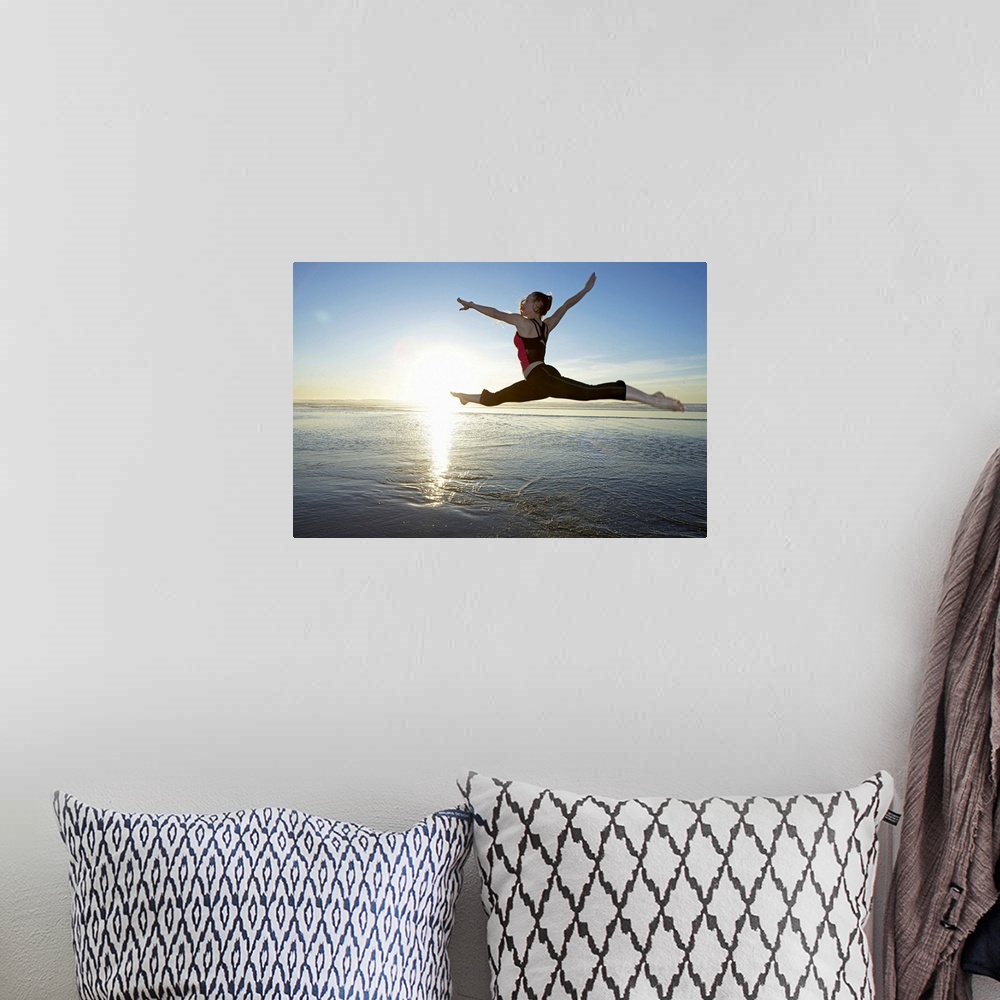 A bohemian room featuring Woman leaping over the ocean