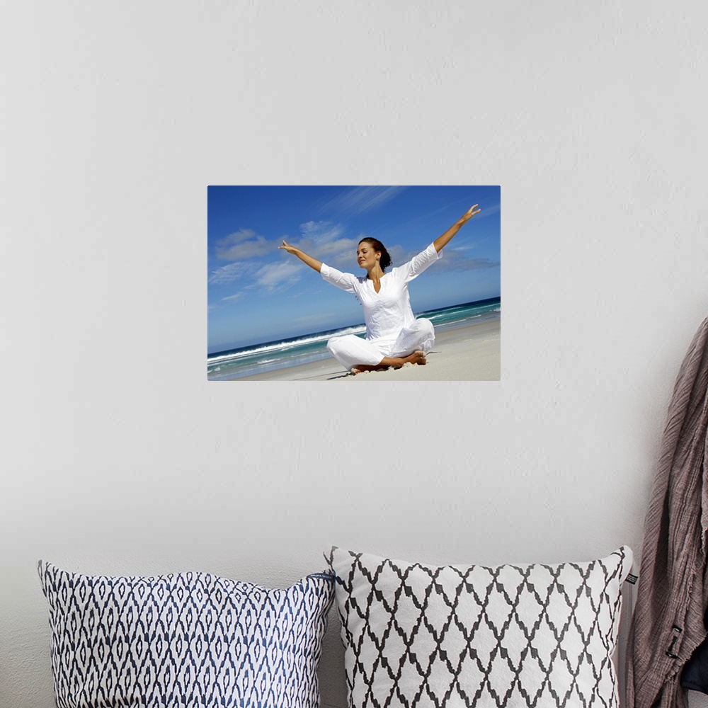 A bohemian room featuring Woman meditating at beach