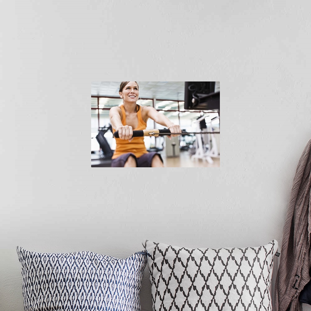 A bohemian room featuring Woman on rowing machine