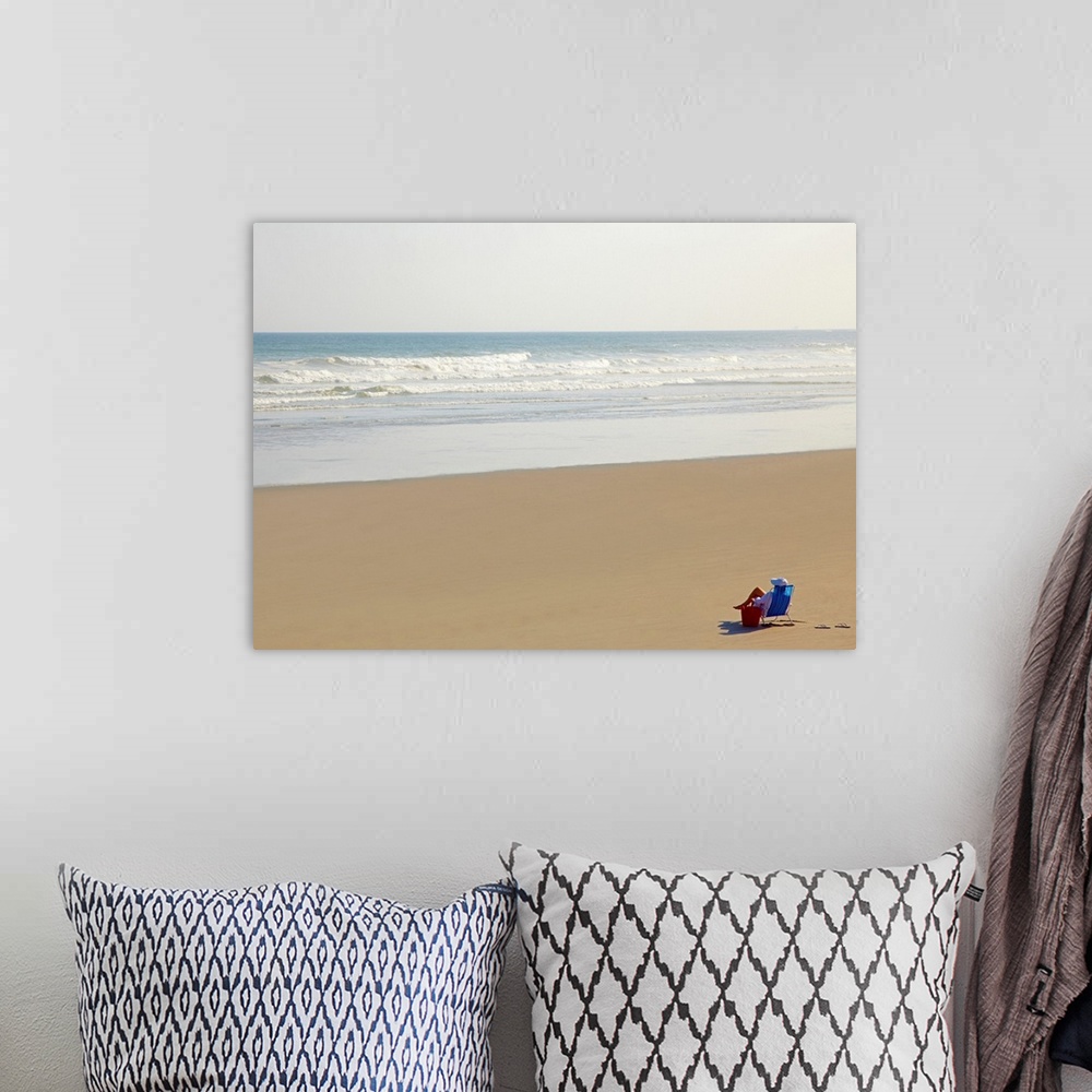 A bohemian room featuring Woman relaxing on beach