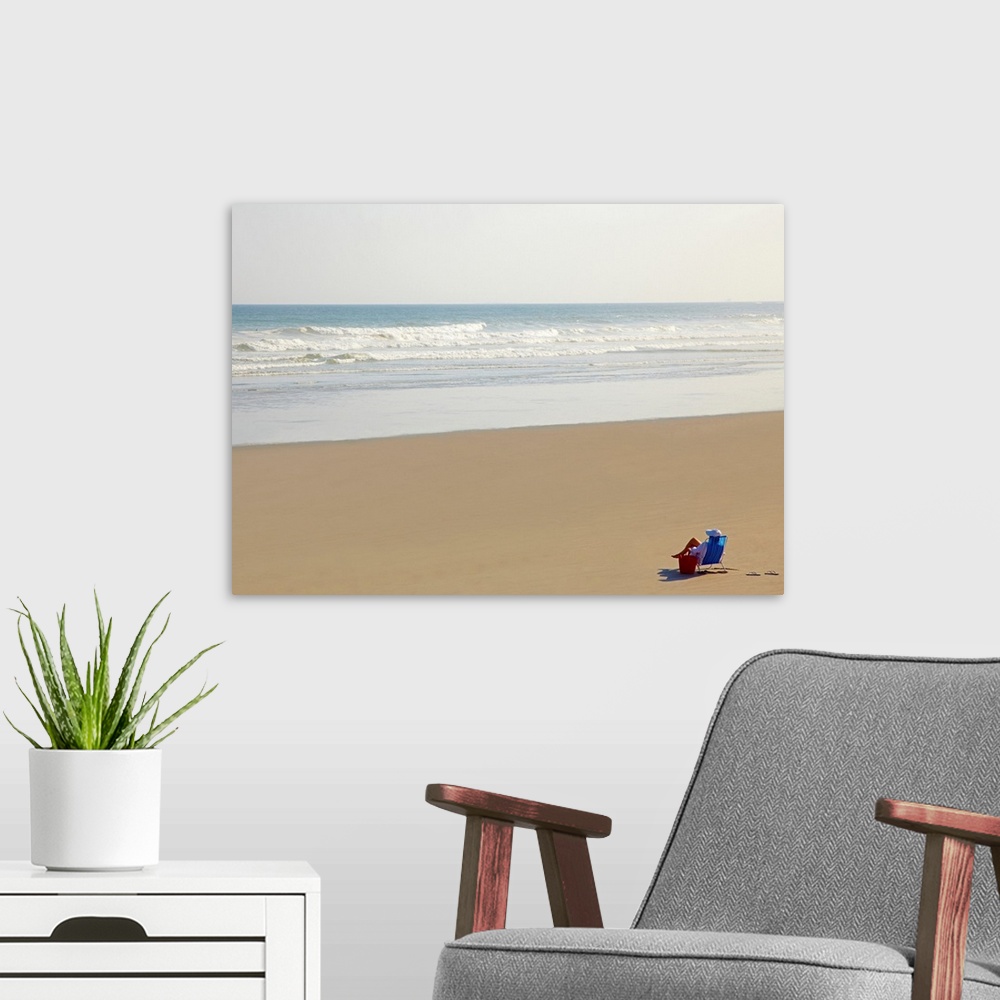 A modern room featuring Woman relaxing on beach