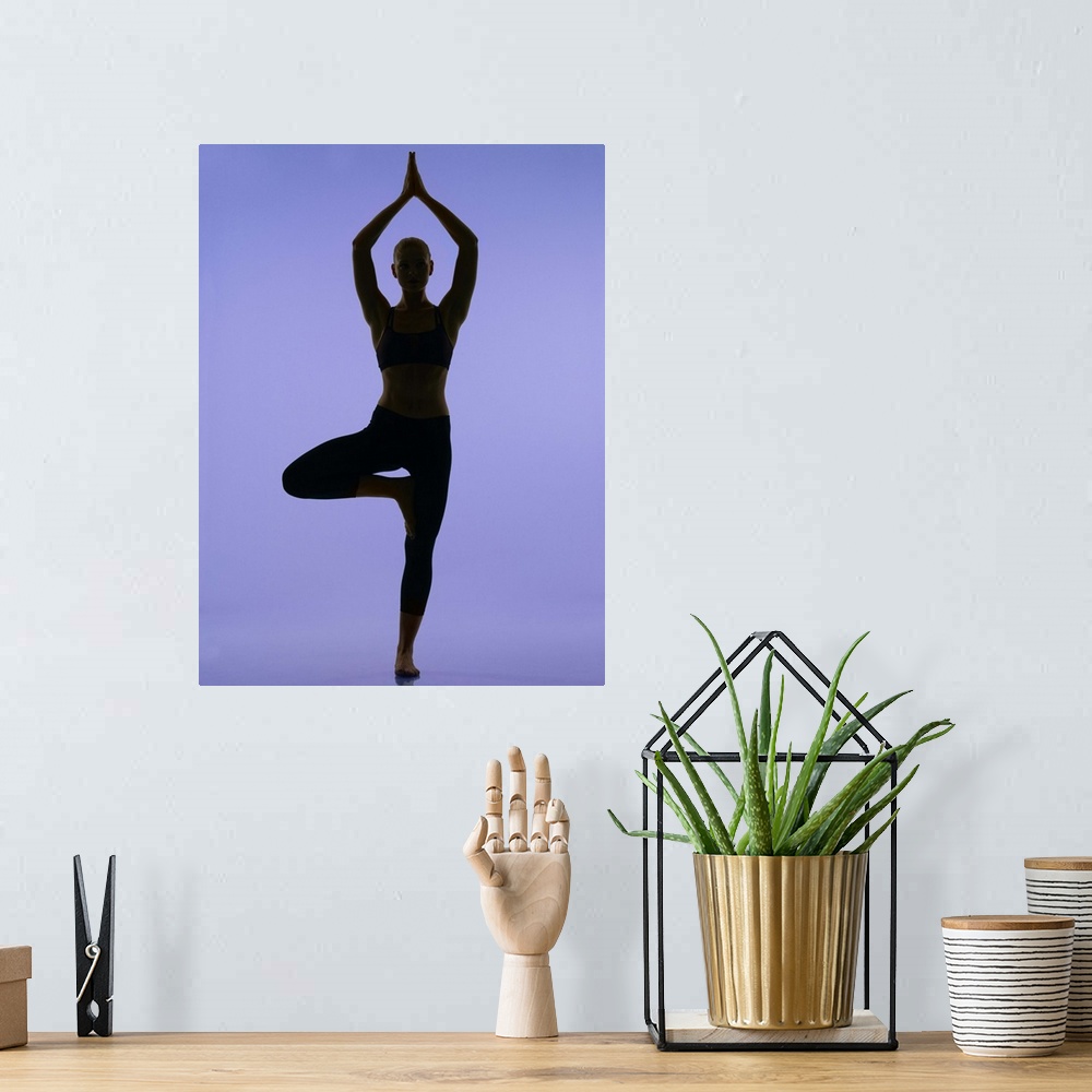 A bohemian room featuring girl doing yoga stretches in silouette on purple background