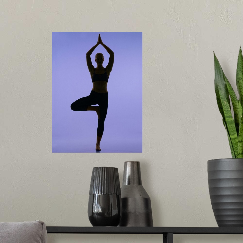 A modern room featuring girl doing yoga stretches in silouette on purple background