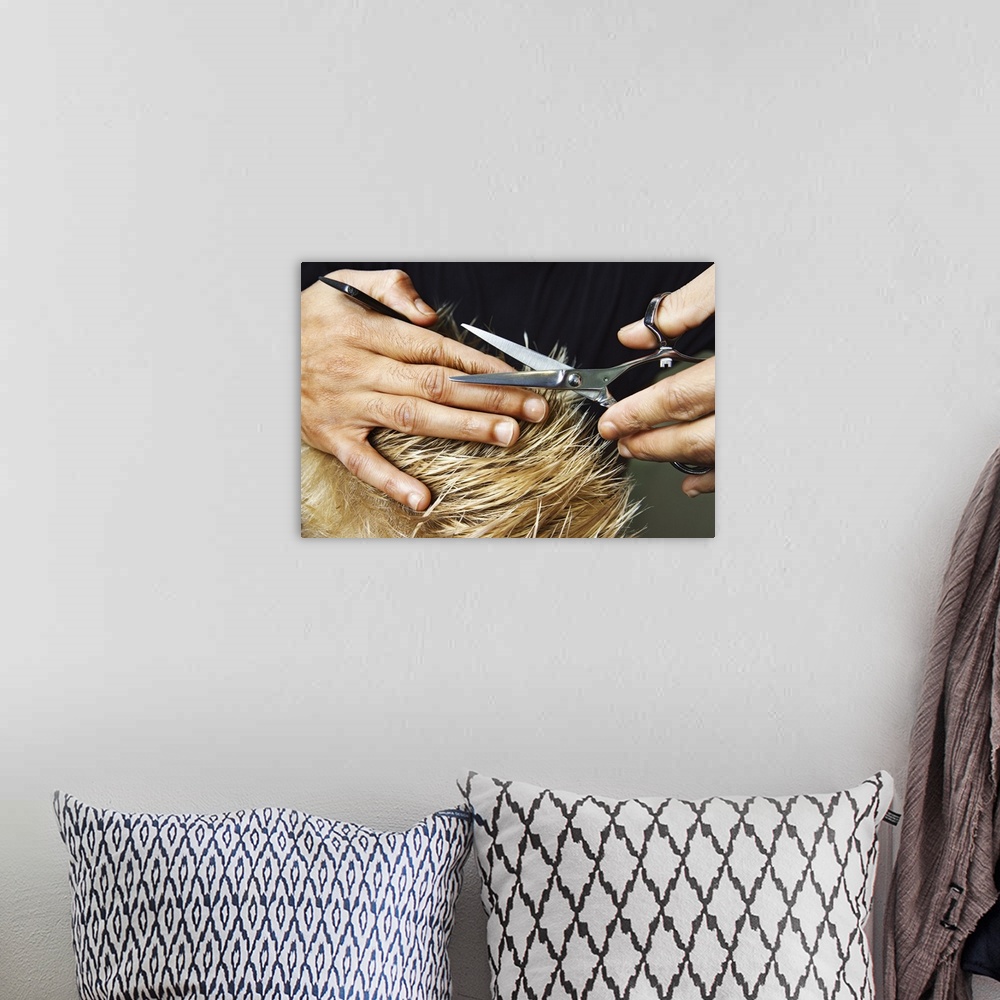 A bohemian room featuring Woman's hands cutting hair