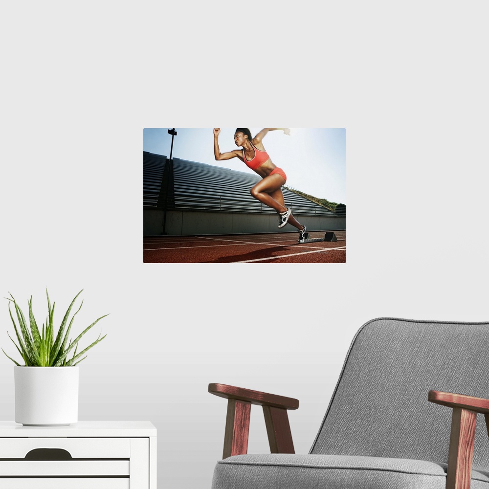 A modern room featuring Women running on athletic track