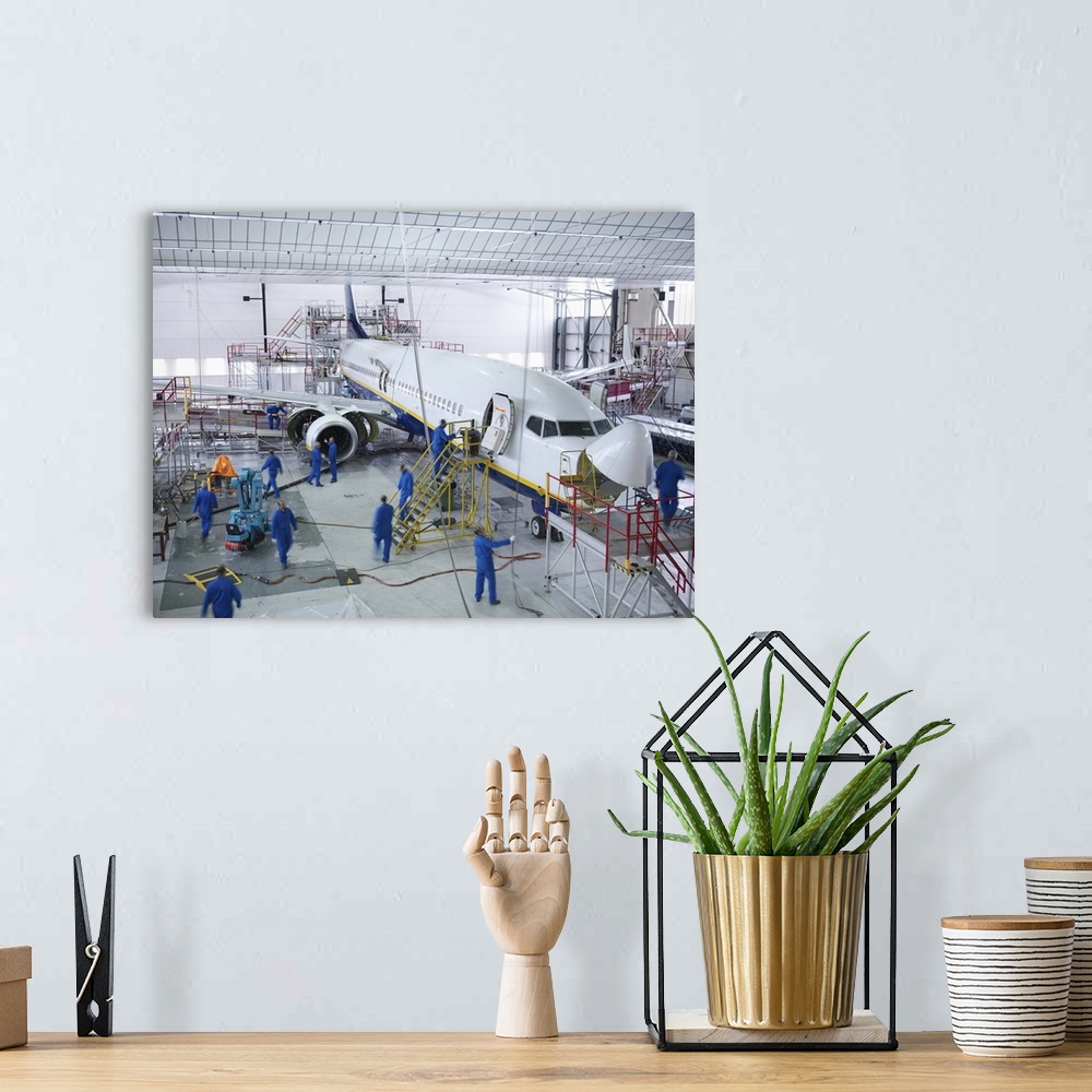 A bohemian room featuring Workers in airplane hangar