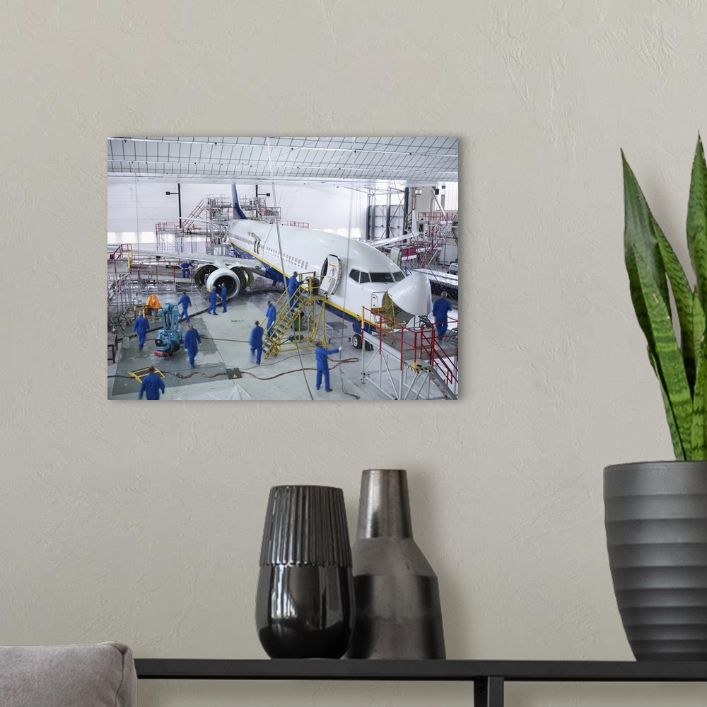 A modern room featuring Workers in airplane hangar
