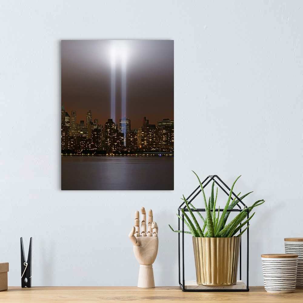 A bohemian room featuring This vertical piece shows two beams of light shining up from where the twin towers stood. The sky...