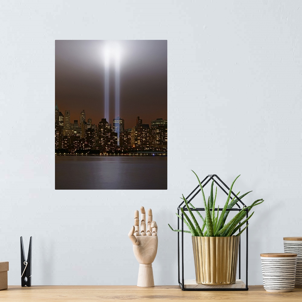 A bohemian room featuring This vertical piece shows two beams of light shining up from where the twin towers stood. The sky...