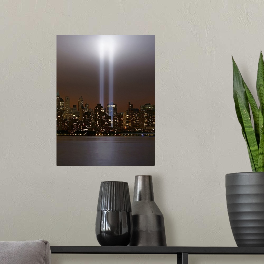 A modern room featuring This vertical piece shows two beams of light shining up from where the twin towers stood. The sky...