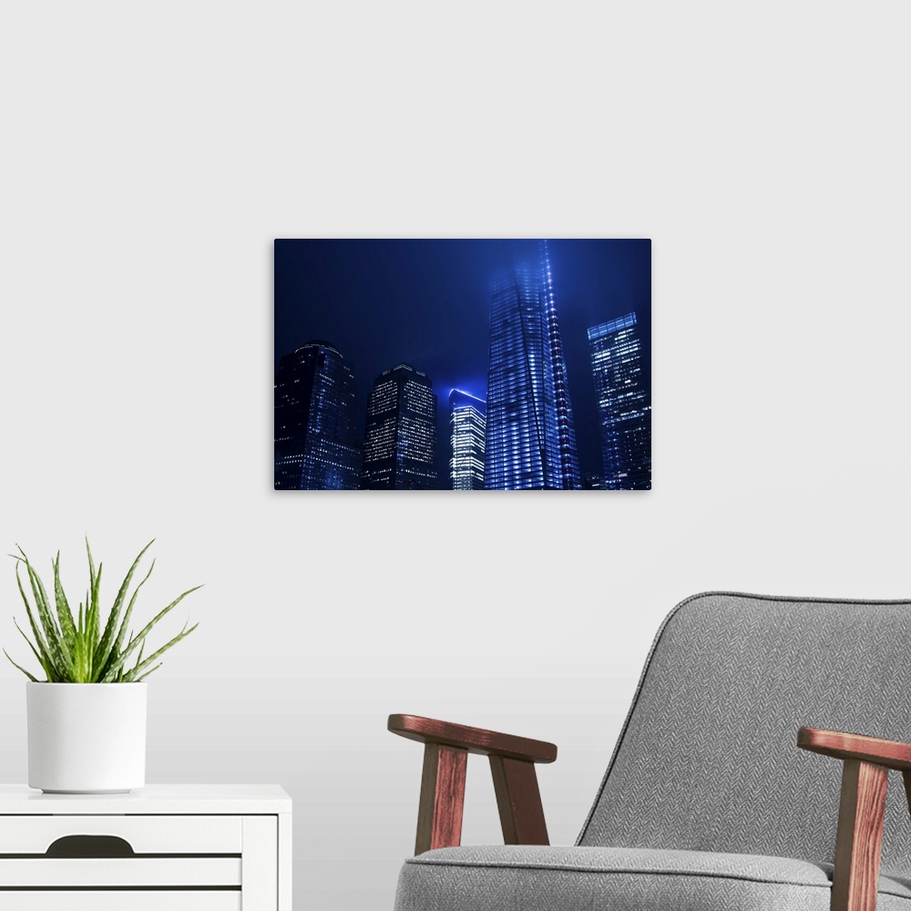 A modern room featuring The WTC and Freedom Tower at night with a cool white balance to give a futuristic effect. Low clo...