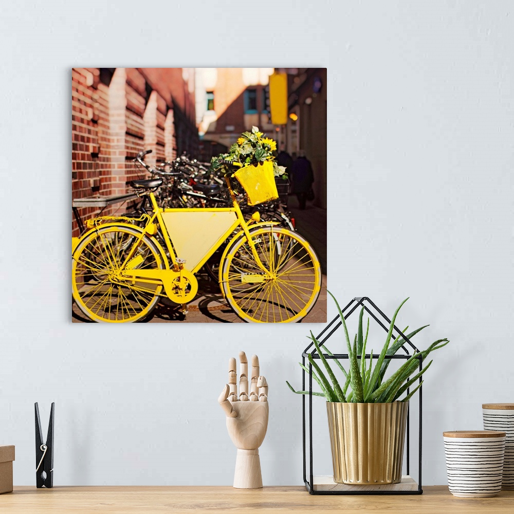 A bohemian room featuring Yellow bike with sunflowers parked outside.